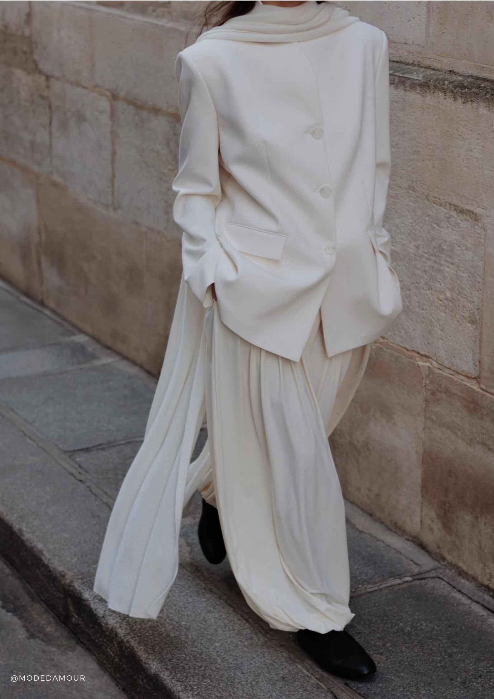 SERENITY Chamonix extra-long cashmere scarf in White, styled over an elegant all-white layered look.