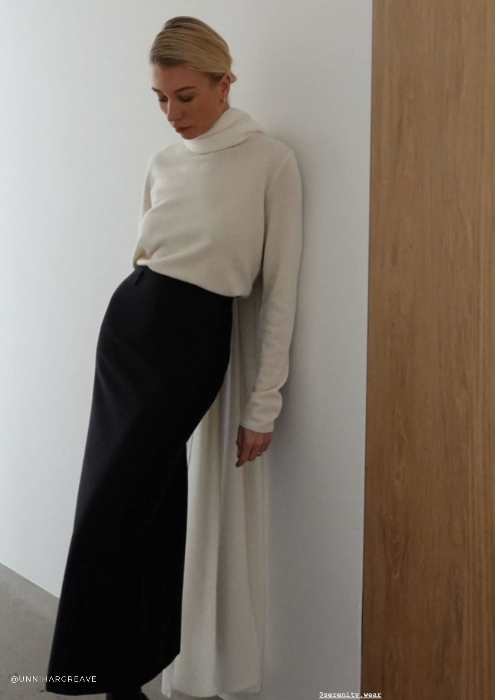 Woman in a white cashmere sweater and extra-long cashmere scarf with a black silk-wool maxi skirt — Aspen sweater, Chamonix scarf and Rowan skirt by SERENITY.